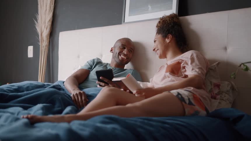 A couple are talking in bed