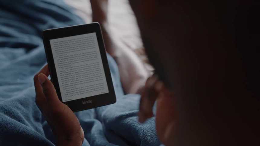 A person reading a book on a kindle ereader
