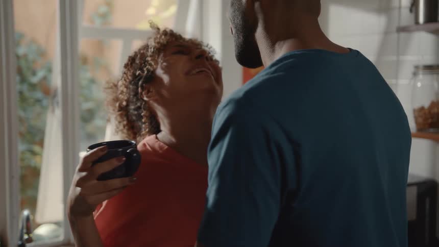 A couple are dancing the kitchen