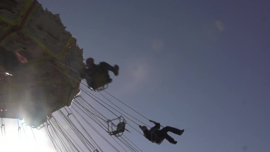 People riding on swing carousel