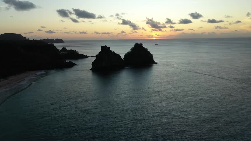 Rock formations in the sea during sunset in fernando de noronha