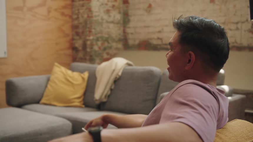 Man sitting on a sofa talking