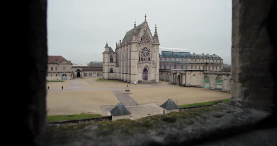 The chteau de vincennes church building stands at midday surrounded by other structures
