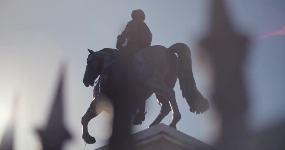 Bronze statue of a person riding a horse
