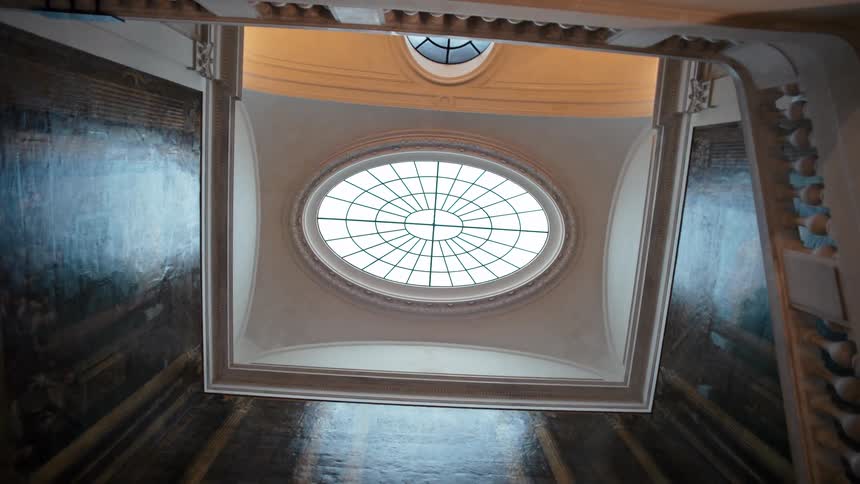 Interior of a cathedral looking upwards with a window in the ceiling