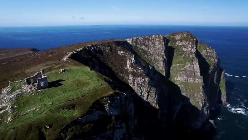 A rocky cliff surrounded by ocean