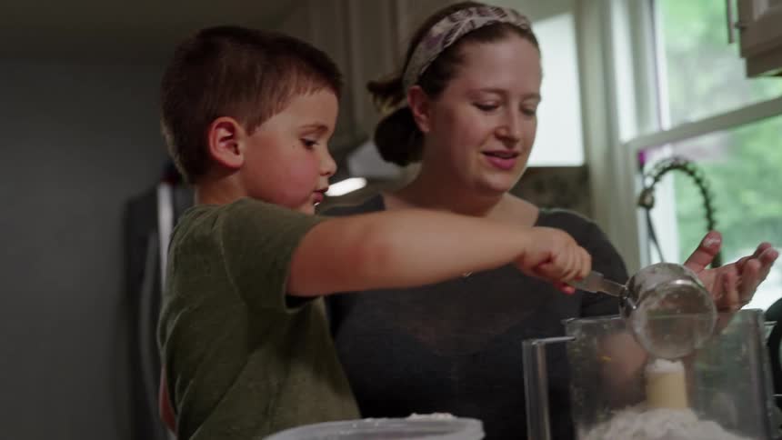 Boy helping his mother cook