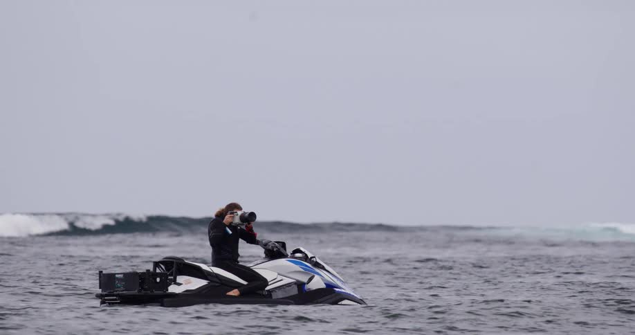 Male filmmaker on a jet ski in the ocean