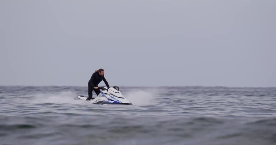 A man rides a jet ski on the ocean