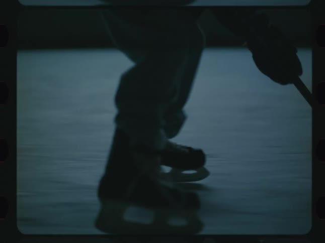 Legs of a person sliding on a hockey rink