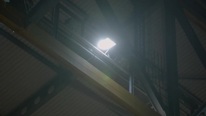 A spotlight in the rafters warms and then lights