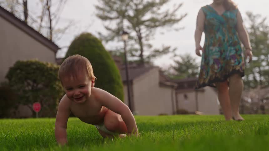 The mother walks after the crawling son