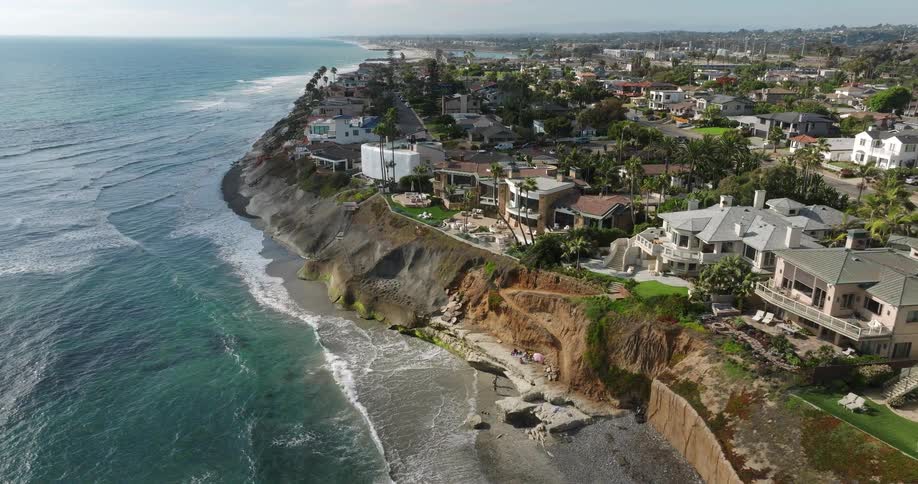 Mansions sit on the edge of a cliff