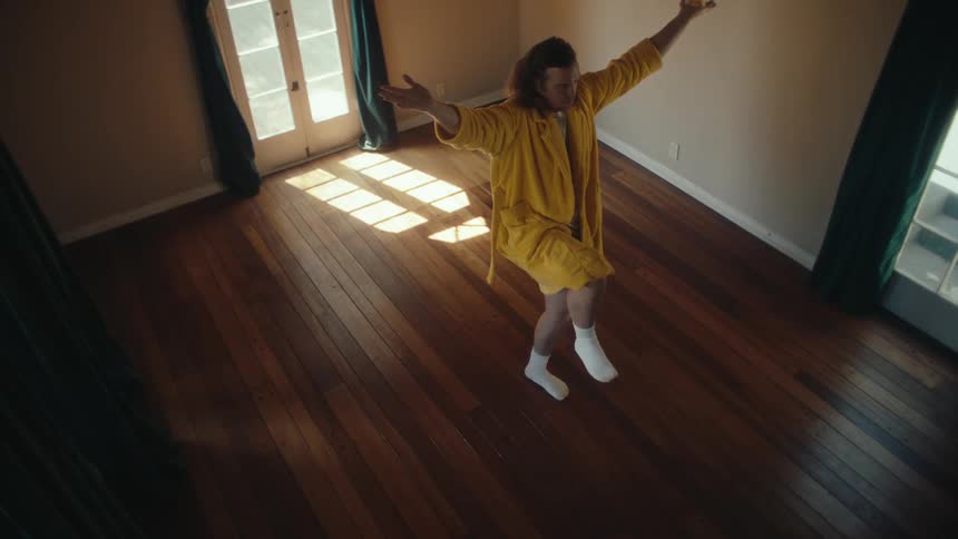 Person poses in an empty sunlit room