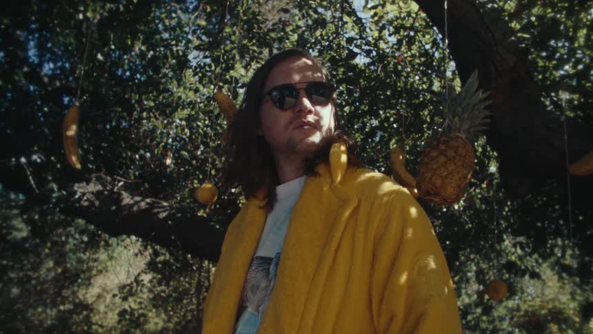 A man is standing under a tree