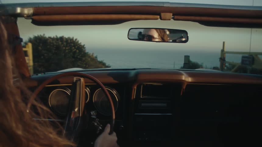 Person driving a convertible car