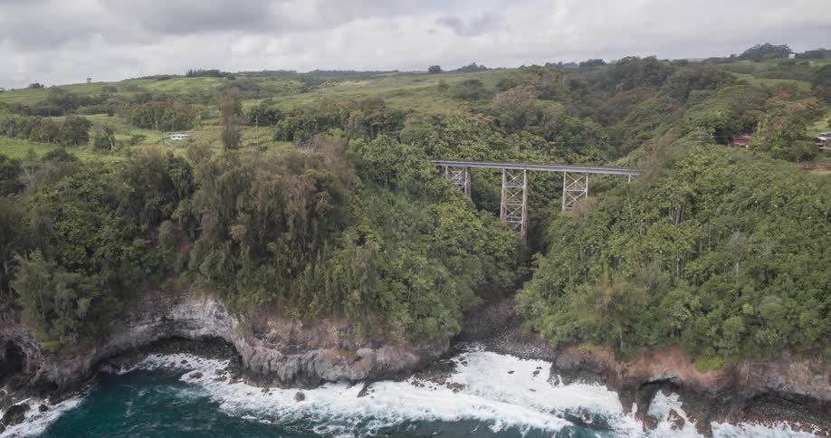 A car travels over the bridge on the mountain