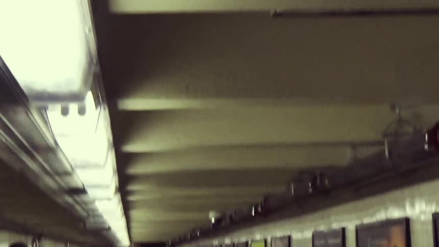 Pedestrians walking towards the subway exit
