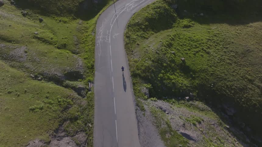 A cyclist riding up a road