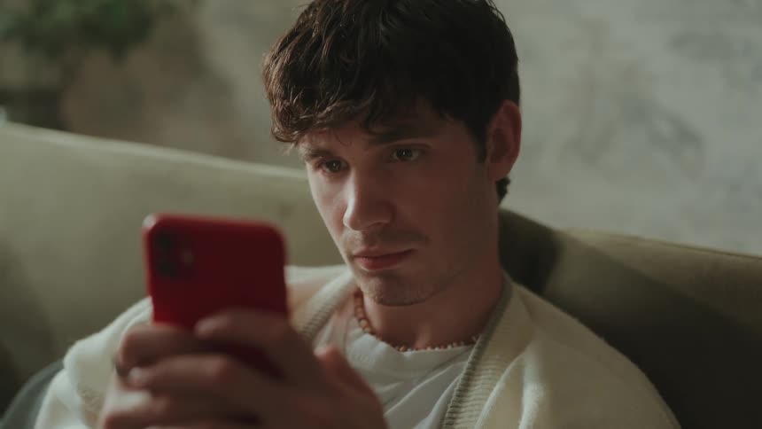 A man looks through his phone