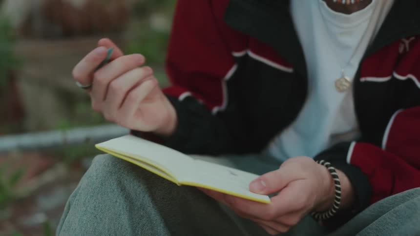 A person writes in a notebook