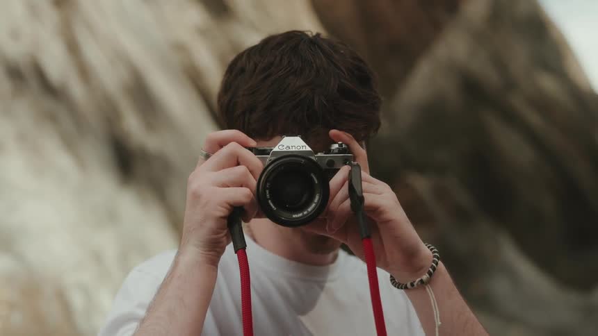 A man points his camera at the camera