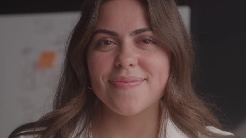A woman smiles at the camera