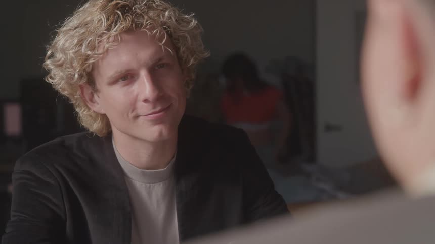 Two people in an indoor environment talking