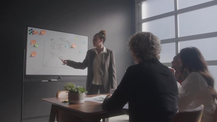 A woman is giving a lecture in the office