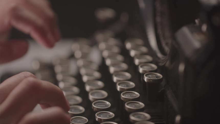 Hands typing on a mechanical typewriter