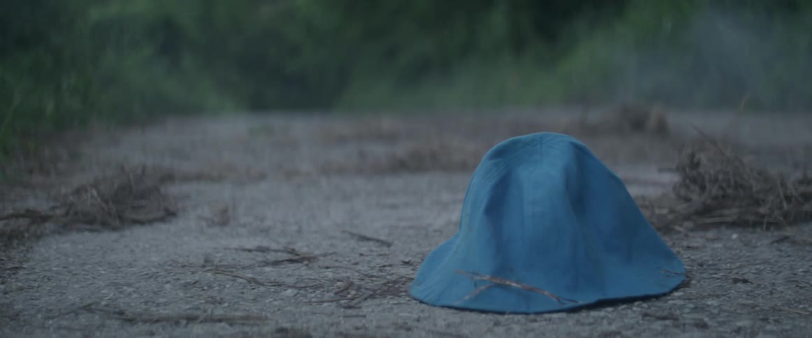 A blue hat rests on the ground