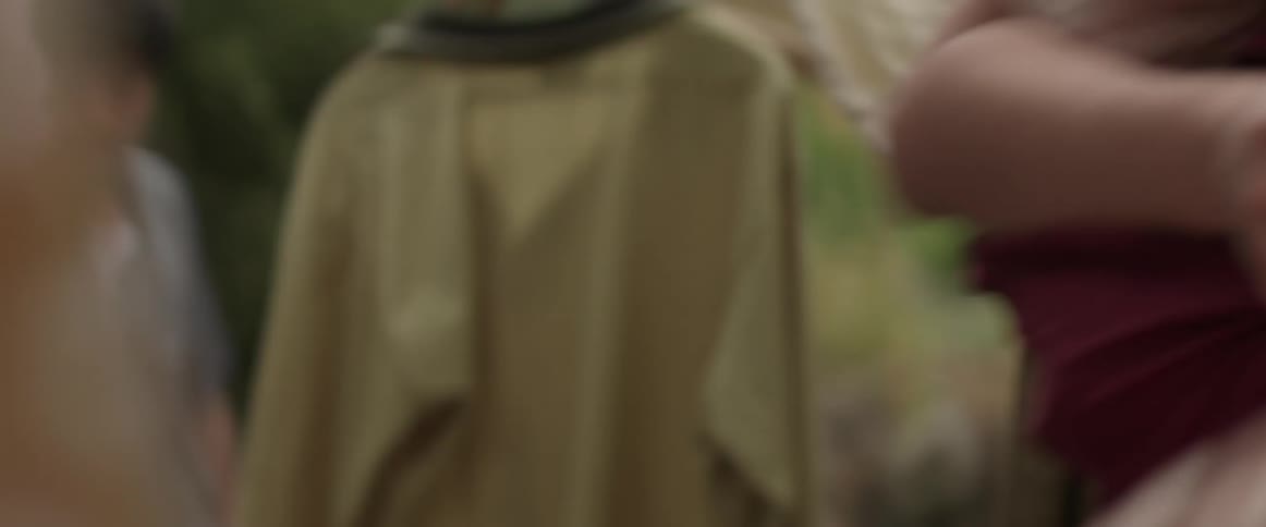 A man holds an asian woman as she struggles to get away