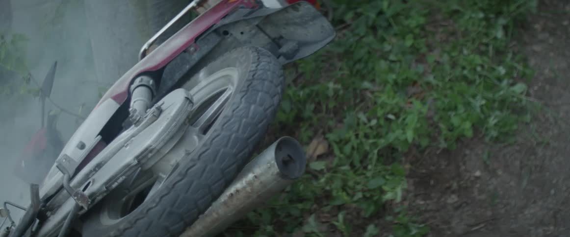 A wrecked motorcycle wheel stops rotating