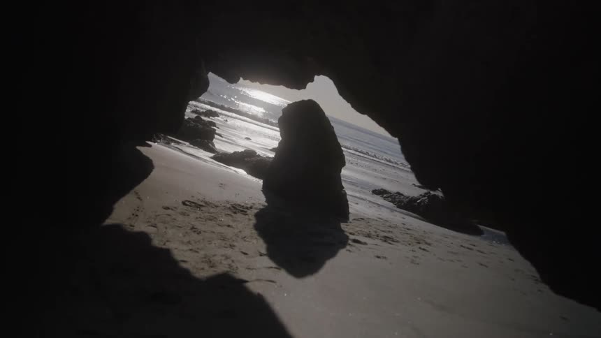 The cave is dark on the beach