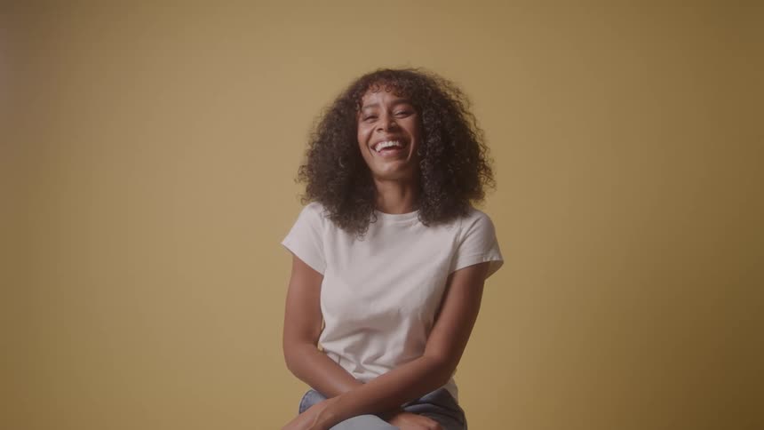 A woman laughs at the camera