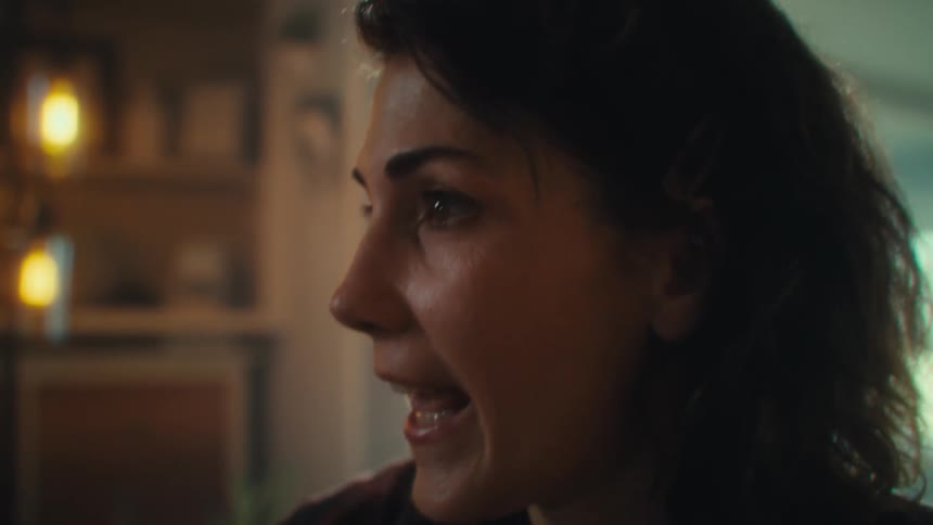 A woman cheers and hugs someone