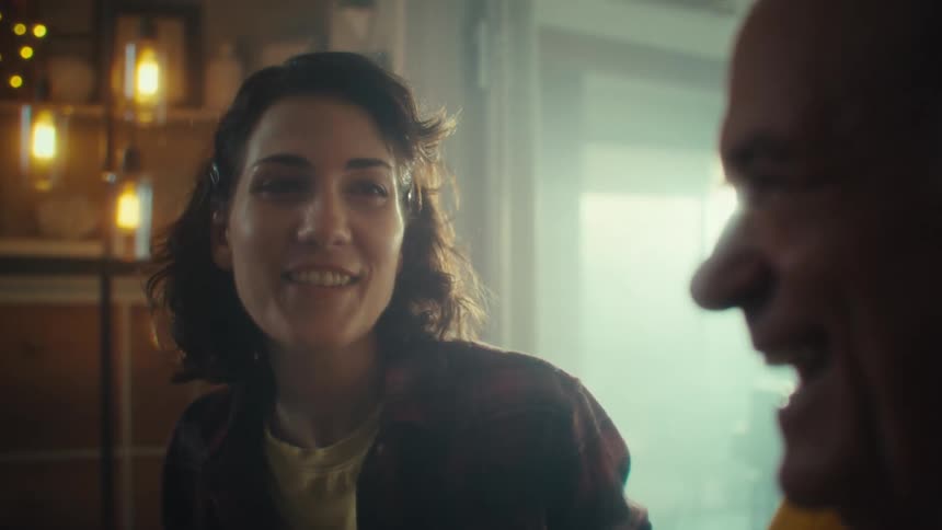 Woman smiling while talking to a man