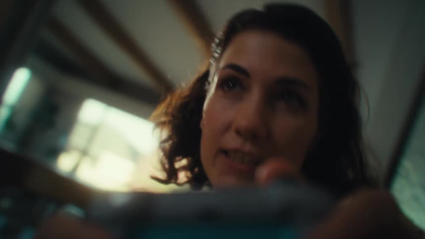 Woman smiling while holding a video game controller