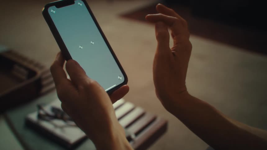 A woman looks at a phone screen