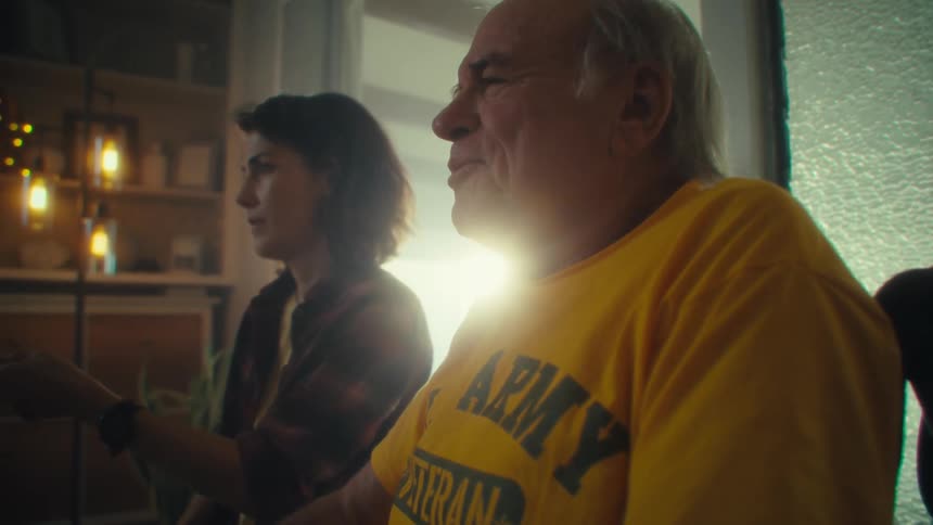Elderly man sitting next to a woman in a room