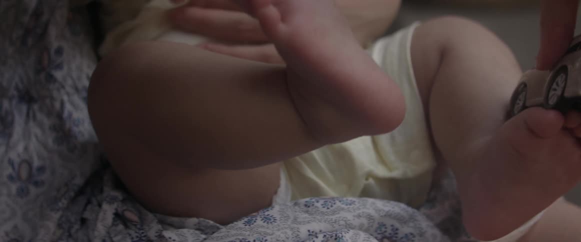 A person wipes a baby's foot