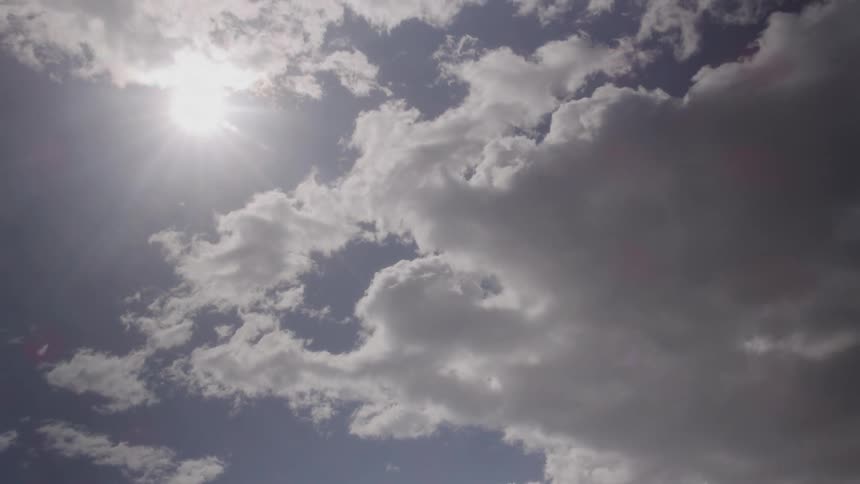 Fluffy clouds move across the sky