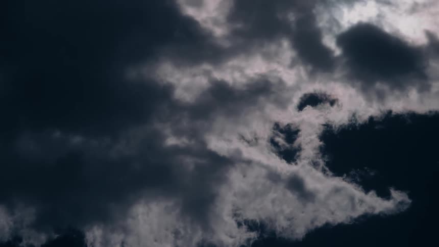 Fluffy clouds pass by overhead