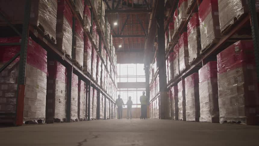 Workers move around the warehouse