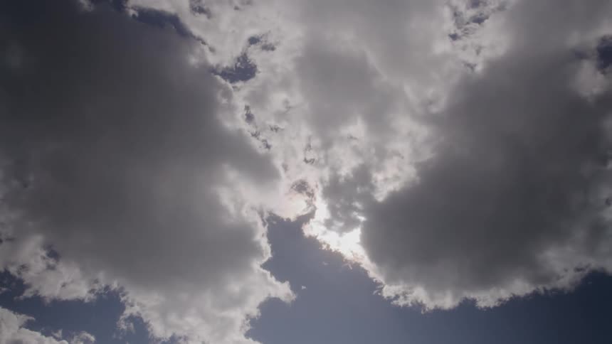 Fluffy clouds move across the sky