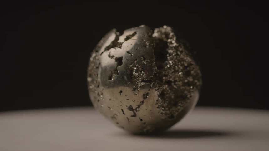 A metal ball is spinning