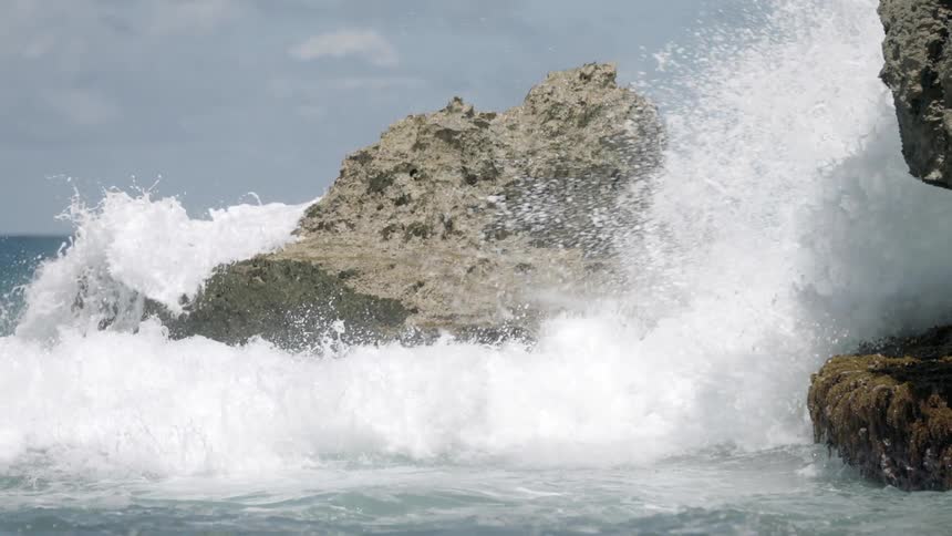 Waves crash against rocks in the water