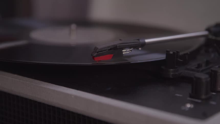 A record player plays a record