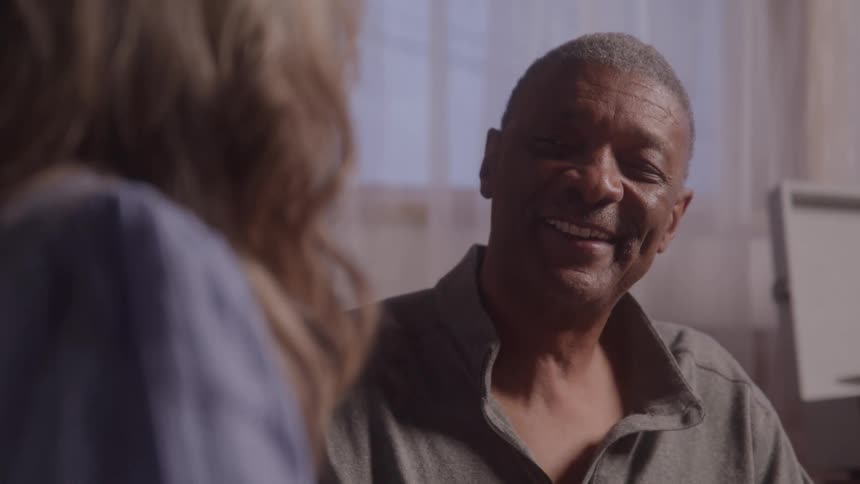 Woman gently touching the face of a smiling man