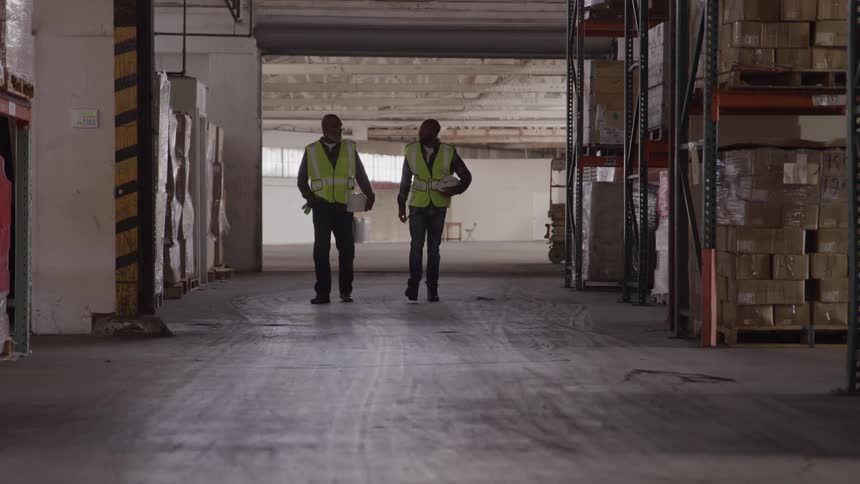 Workers in a crate storage warehouse